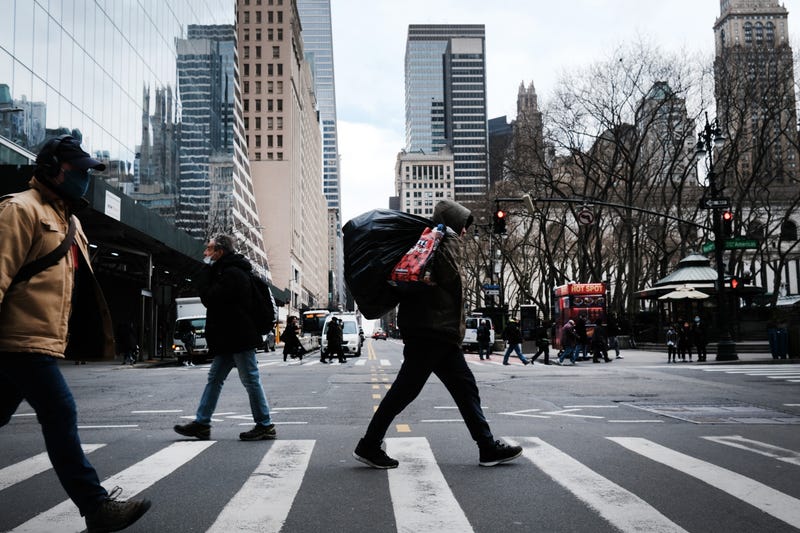 People walk through the streets of Manhattan on March 01, 2021 in New York City