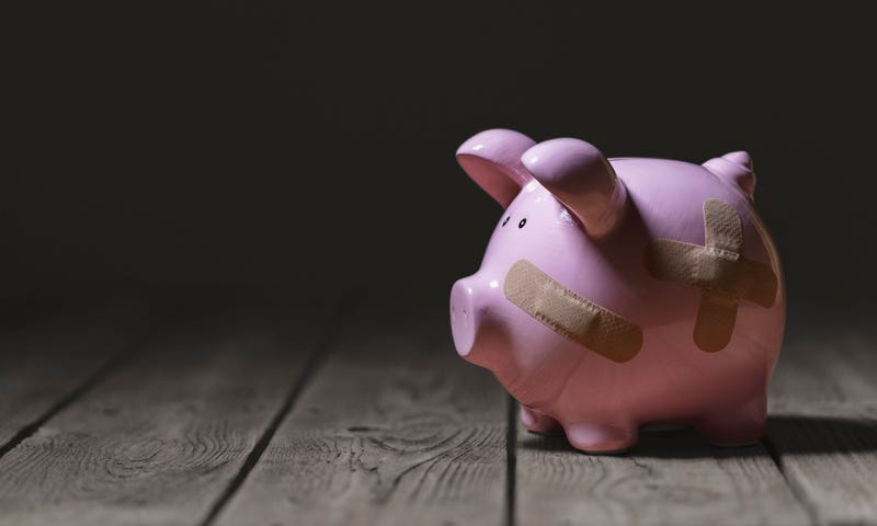 Piggy bank with bandaids on it.