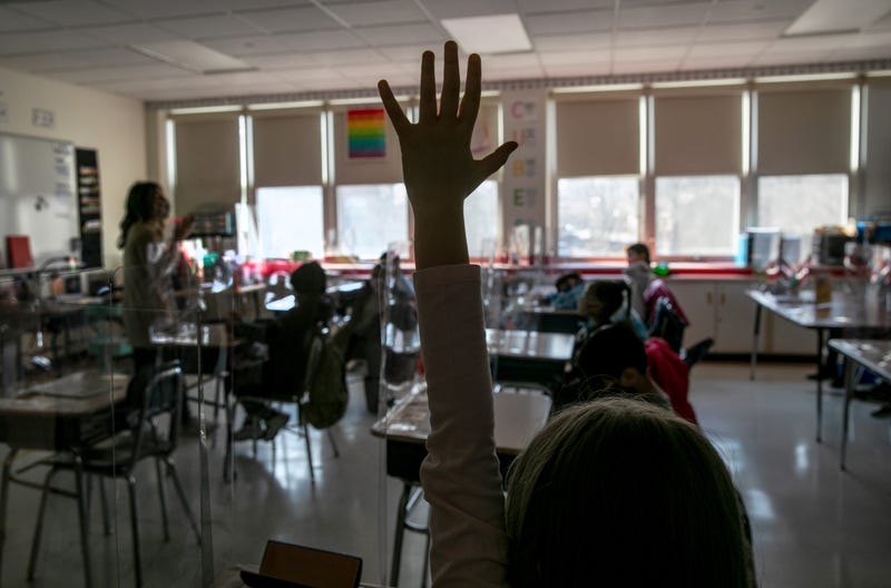 Third grade literacy instructor Katelyn Battinelli (L), speaks with students about their pandemic-related fears on the first day of in-person learning for five days per week at Stark Elementary School on March 10, 2021 in Stamford, Connecticut