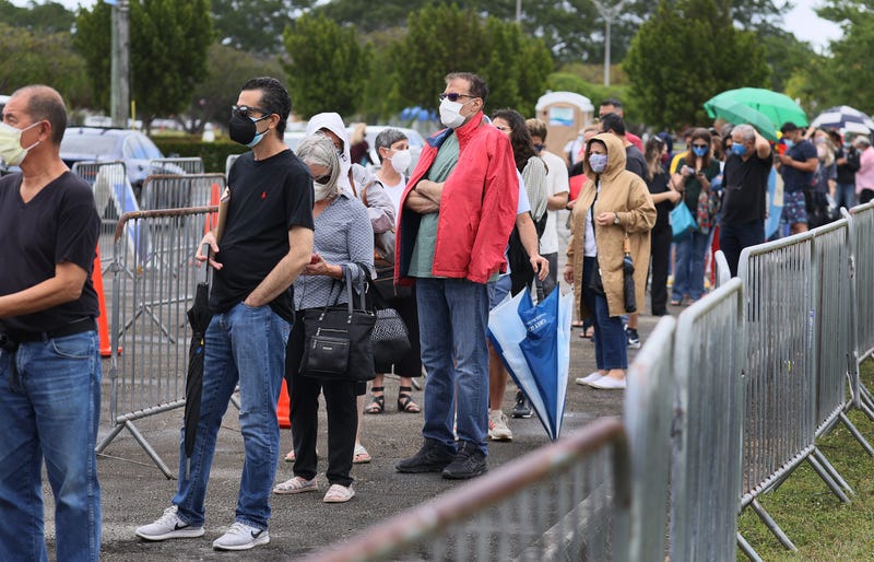 People stand in line to receive a COVID-19 vaccine at the Miami Dade College North Campus on March 10, 2021 in North Miami, Florida