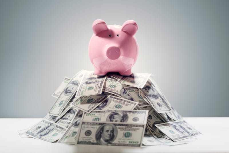Piggy bank on pile of money concept