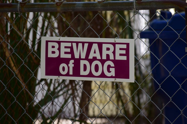 beware of dog sign on fence