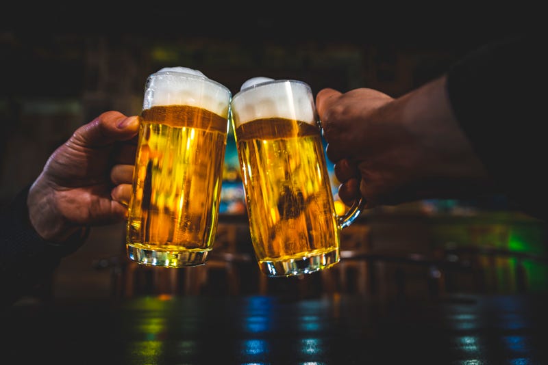 two beer glasses doing a cheers