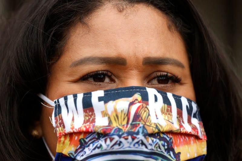 San Francisco Mayor London Breed wears a face mask that says "We Rise" during a news conference outside of Zuckerberg San Francisco General Hospital with essential workers to mark the one year anniversary of the COVID-19 lockdown on March 17, 2021 in San Francisco,