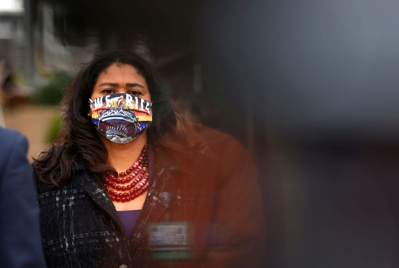 San Francisco Mayor London Breed wears a face mask that says "We Rise" during a news conference outside of Zuckerberg San Francisco General Hospital with essential workers to mark the one year anniversary of the COVID-19 lockdown on March 17, 2021 in San Francisco, California.