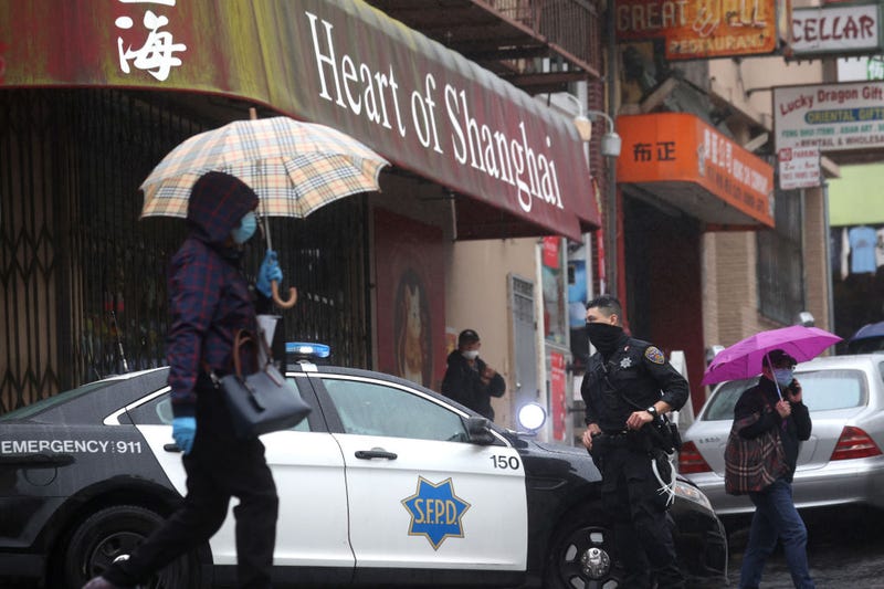 San Francisco police officer William Ma stands guard on a street corner in Chinatown on March 18, 2021 in San Francisco, California.