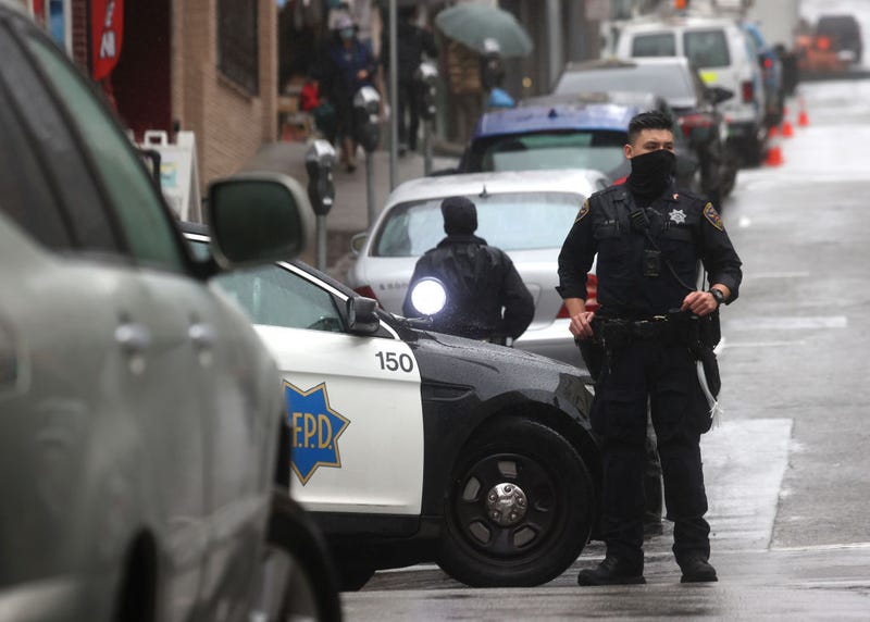 San Francisco police officer William Ma stands guard on a street corner in Chinatown on March 18, 2021 in San Francisco, California.