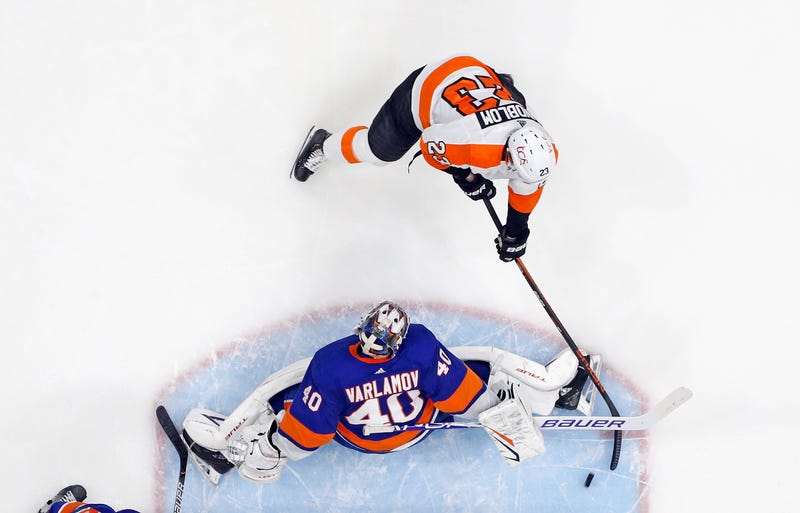 UNIONDALE, NEW YORK - MARCH 18: Oskar Lindblom #23 of the Philadelphia Flyers scores a second period goal against Semyon Varlamov #40 of the New York Islanders at the Nassau Coliseum on March 18, 2021 in Uniondale, New York. The Flyers defeated the Islanders 4-3.
