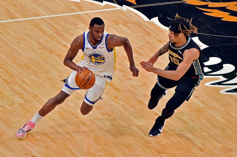  Andrew Wiggins #22 of the Golden State Warriors handles the ball against Brandon Clarke #15 of the Memphis Grizzlies during the second half at FedExForum on March 19, 2021 in Memphis, Tennessee.