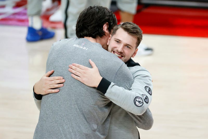 Boban Marjanovic #51 and Luka Doncic #77 of the Dallas Mavericks embrace before the game against the Portland Trail Blazers at Moda Center on March 19, 2021.