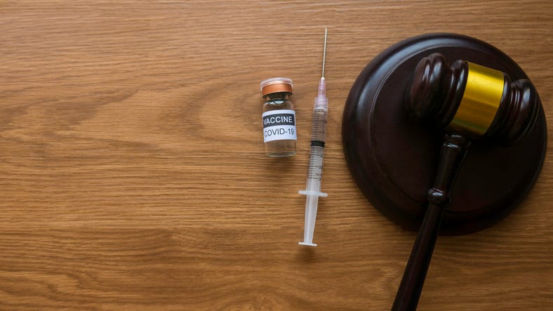 Gavel and COVID-19 vaccine.