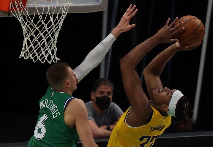 Myles Turner fights for a shot against Kristaps Porzingis.