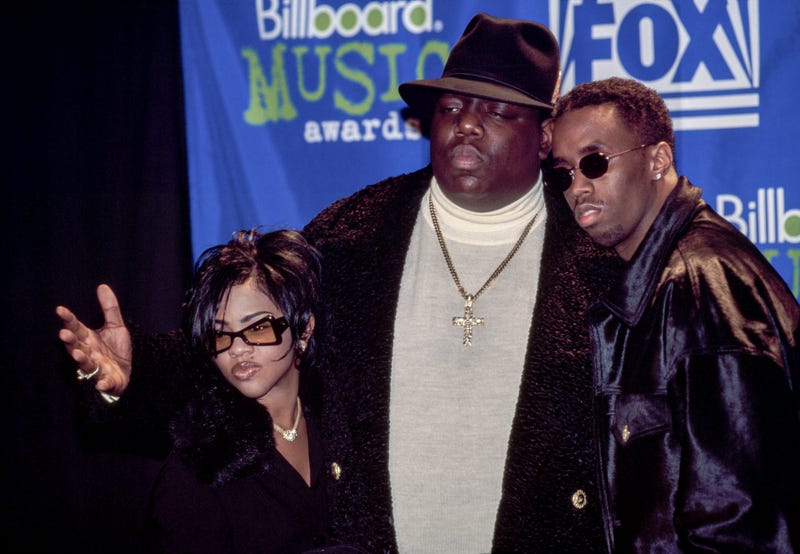 Rapper Notorious B.I.G. AKA Biggie Smalls (Christopher Wallace) joined by Sean (Puffy) Combs and Lil' Kim receives Billboard Music Award on December 6, 1995 at The Coliseum in New York City