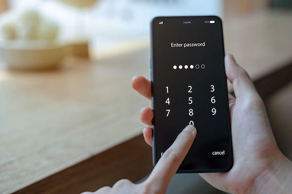 Woman entering password on smartphone
