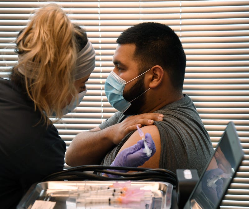 A man receives his coronavirus vaccination