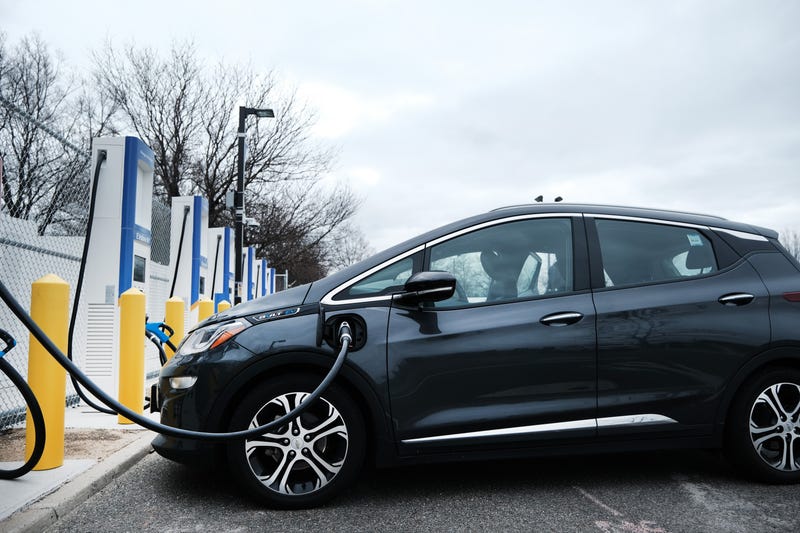 A driver uses a fast-charging station for electric in the cell phone lot at John F. Kennedy (JFK) airport on April 02, 2021.