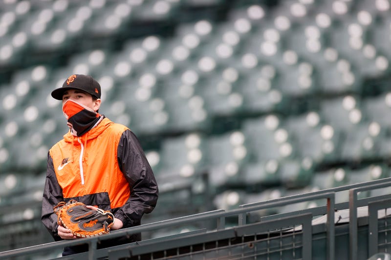 A fan watches batting practice before the game between the Seattle Mariners and the San Francisco Giants at T-Mobile Park on April 03, 2021 in Seattle, Washington.