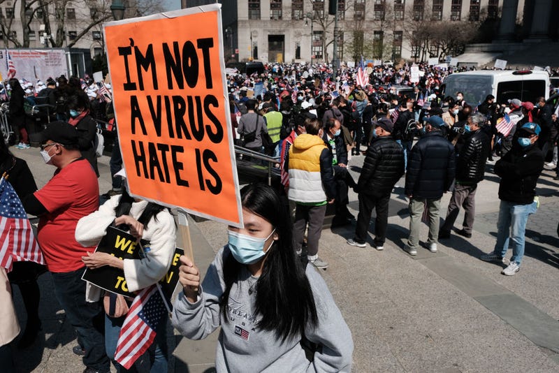 People participate in a protest to demand an end to anti-Asian violence .