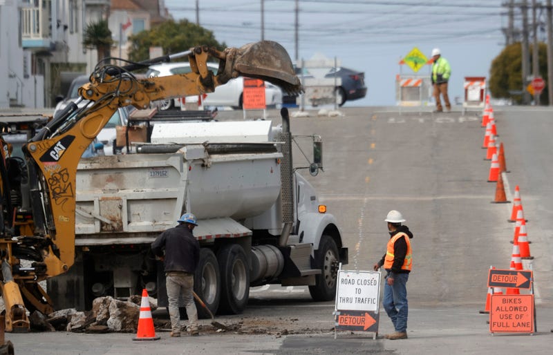 Workers dig a hole in the street as they make infrastructure repairs on April 07, 2021 in San Francisco, California.