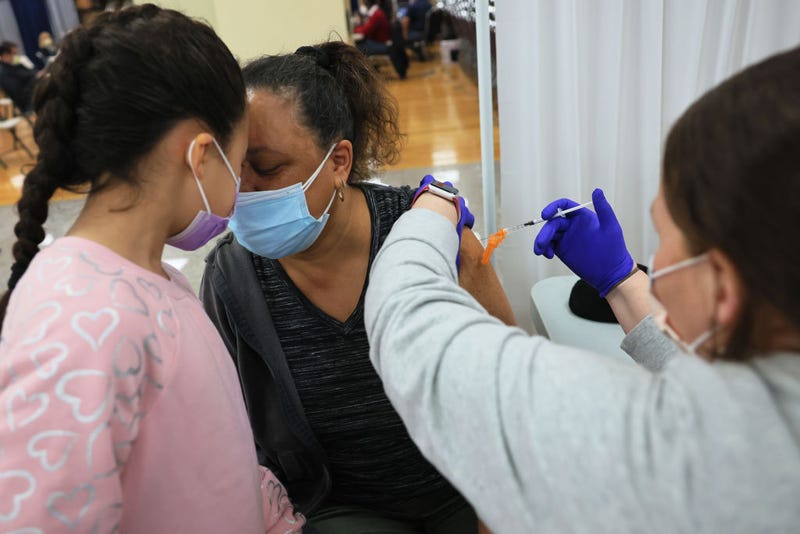 Mia Rosado, 8, rests her head on her grandmother Jacquline Flynn as she is administered the Johnson & Johnson coronavirus (COVID-19) at the Northwell Health pop-up coronavirus (COVID-19) vaccination site at the Albanian Islamic Cultural Center in Staten Island on April 08, 2021 in New York City. NYC continues to have a 6.55 percent coronavirus (COVID-19) cases on a seven-day rolling average as the city continues to ramp up vaccinations. The city last week set a record of 524,520 coronavirus (COVID-19) vaccinations. 