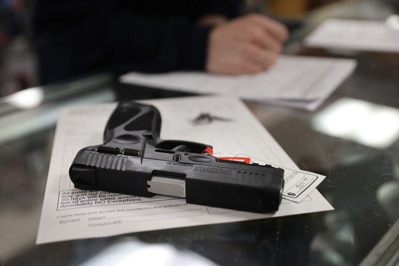 A customer purchases a gun at Freddie Bear Sports on April 08, 2021 in Tinley Park, Illinois.