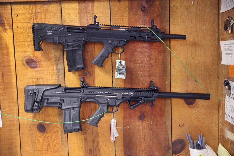 A pair of ghost guns hanging on a wall