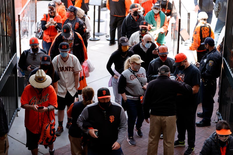San Francisco Giants fans enter the stadium for the Giants home opener against the Colorado Rockies at Oracle Park on April 09, 2021 in San Francisco, California.