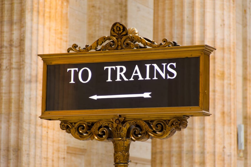 The Great Hall of Chicago's Union Station showing close-up of illuminated floor sign To Trains and large pillars in background