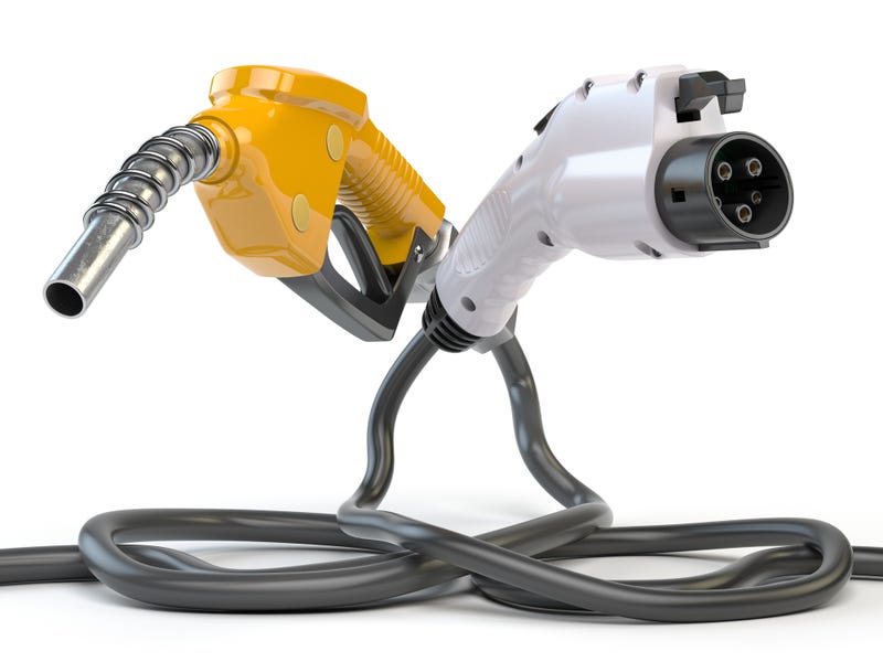 Electric vehicle EV charging plug and gas nozzle isolated on white