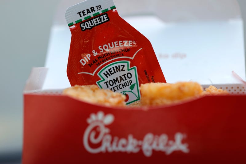 A packet of Heinz ketchup is displayed with Chick-fil-A hash browns