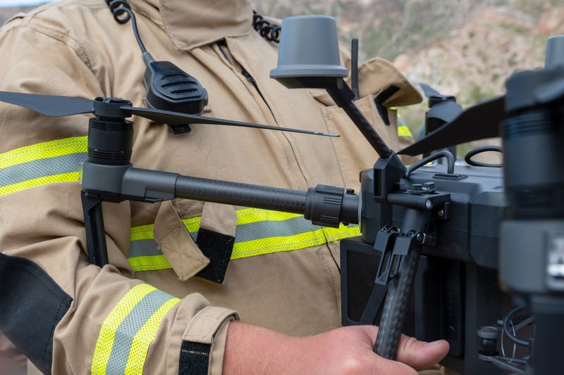 Firefighter operating drone in search and rescue