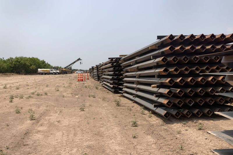 Unused pieces of steel bollard-style wall lay near a portion of unfinished border wall at the U.S.-Mexico border on April 14, 2021 in La Joya, Texas.