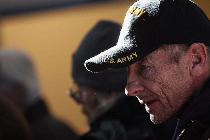 A homeless U.S. military veteran stands in line for free winter clothing.
