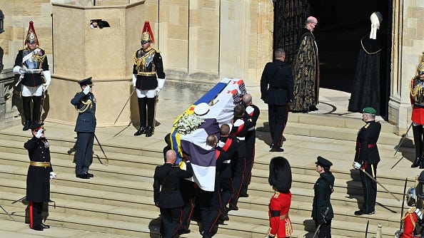 Prince Philip is laid to rest as somber queen sits alone