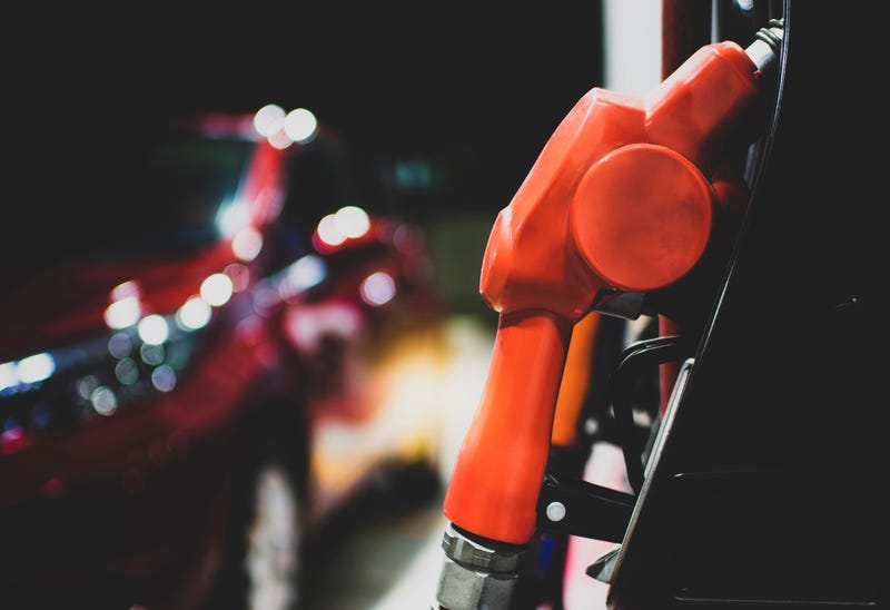 car at gas station pump