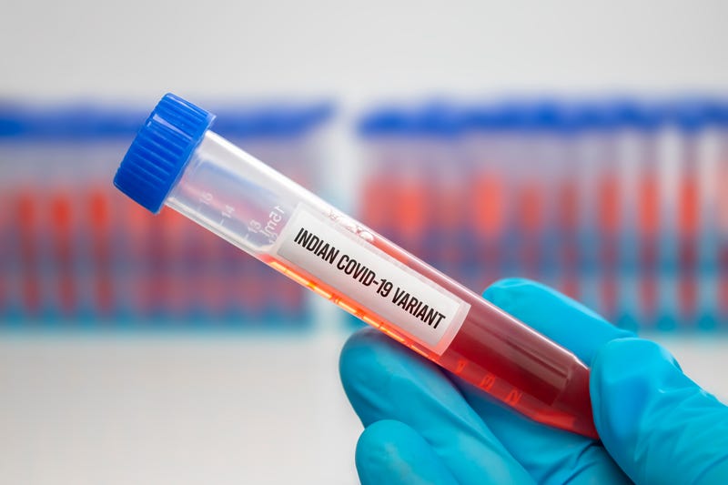 A medical Worker holding a centrifuge tubes with graduated marks with a Covid-19 Indian variant virus sample.