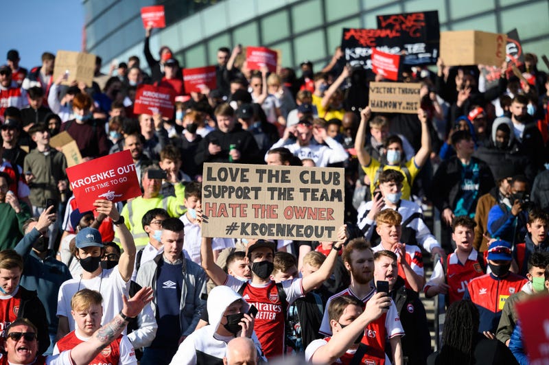 Arsenal fans chant and hold placards during a protest against the club's owner Stan Kroenke ahead of the Premier League match between Arsenal and Everton, outside Emirates Stadium on April 23, 2021 in London, England.