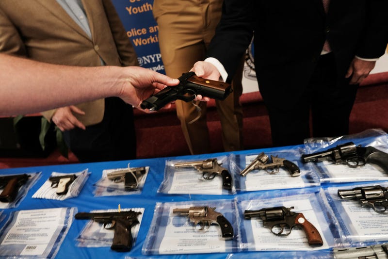 Guns are displayed on a table during a gun buy-back event at a church in Staten Island on April 24, 2021 in New York City.