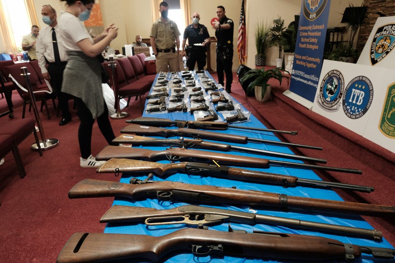 Guns are displayed on a table during a gun buy-back event at a church in Staten Island on April 24, 2021 in New York City. The one-day event, held at Calvary Chapel in Mariners Harbor, will pay a $200 pre-paid card to those who turn in an operable handgun or assault rifle, the department said. About 50 guns had been turned to the church by the early afternoon and no questions are asked to the origins of the weapon. The NYPD, the district attorney and others have organized the event as gun arrests have more than doubled so far this year on Staten Island. People can also receive a $25 pre-paid card for rifles, shotguns and airguns.