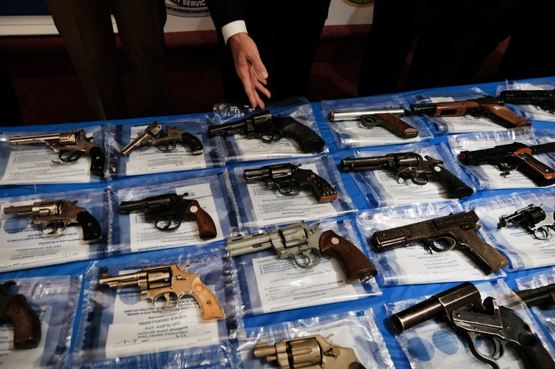 Guns displayed on a table during a gun buy-back event.