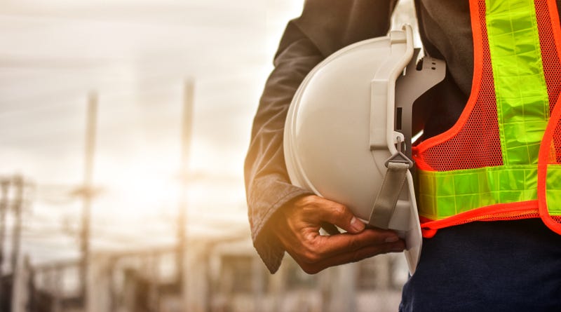 person holding hard hat