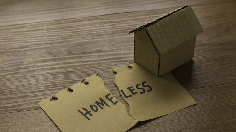 A tear paper written with Homeless and cardboard house - stock photo