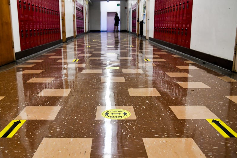 A hallway with social distance decal reminders are seen at Hollywood High School on April 27, 2021 in Los Angeles, California. Los Angeles Unified School District middle and high schools have reopened this week for in-person instruction.