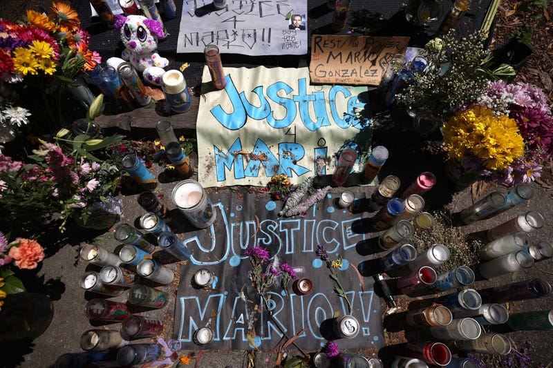 Candles, flowers and photographs are displayed at a memorial for Mario Gonzalez who died after being pinned by Alameda police officers on April 29, 2021 in Alameda, California.