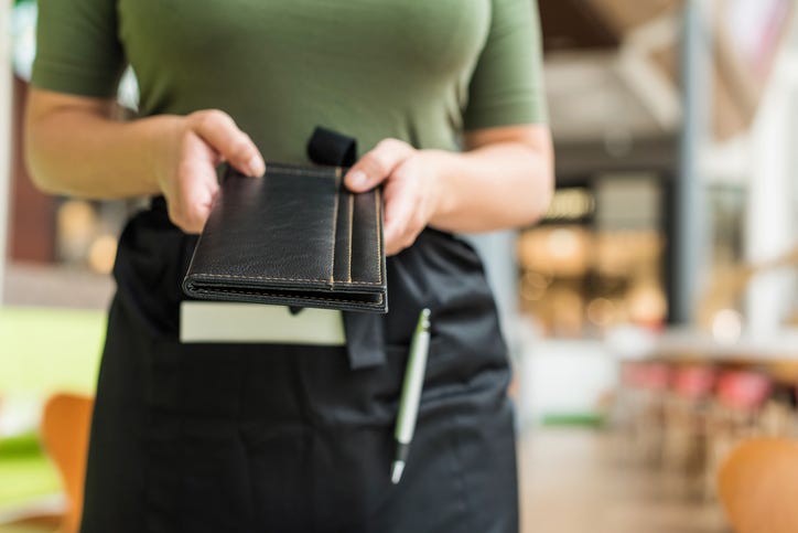 a server delivering a bill at a restaurant 