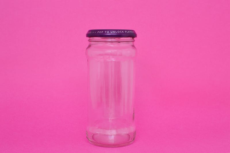 Jar on pink background stock photo.