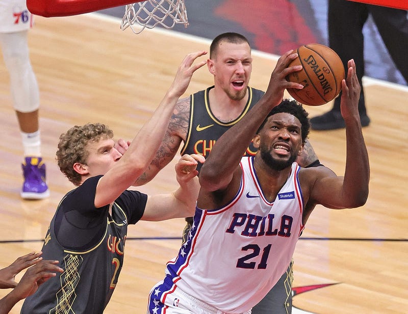 Joel Embiid #21 of the Philadelphia 76ers tries to get off a shot under pressure from Daniel Theis #27 and Patrick Williams #44 of the Chicago Bulls at the United Center on May 03, 2021 in Chicago, Illinois. The 76ers defeated the Bulls 106-94.
