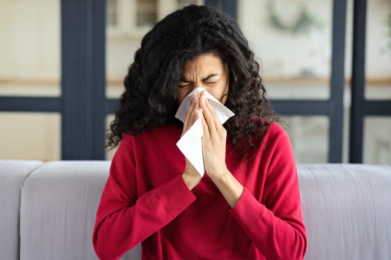 Woman sneezing stock photo.
