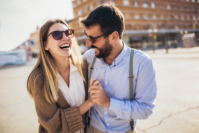 Couple in love walking embracing in street on romantic trip
