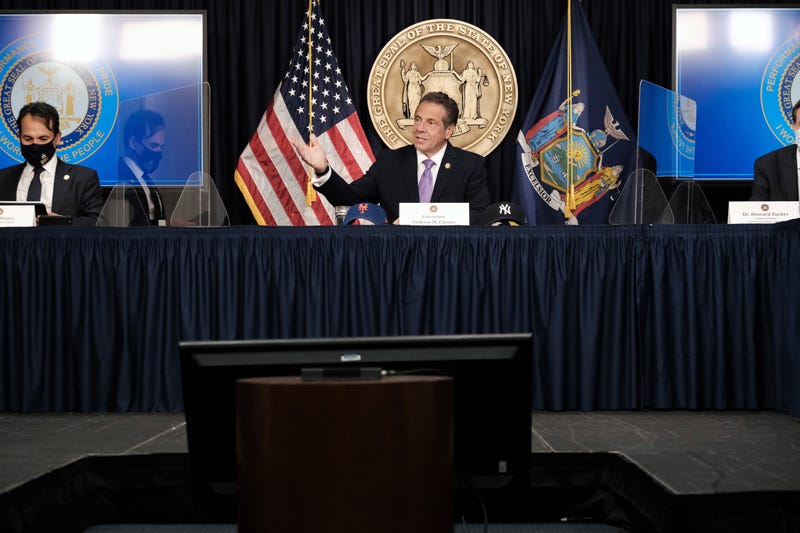 Governor Andrew Cuomo (C) speaks to the media at a news conference in Manhattan on May 5, 2021 in New York City
